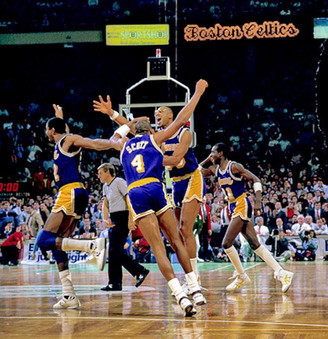 Picture of Lakers players Magic Johnson, Byron Scott, Kareem Abdul-Jabbar and Michael Cooper celebrating at the Boston Garden on Dec 11, 1987. Magic has just made a long jumper as time expired to give the Lakers the win 115-114. Regular Season 1987-88. Photo by Steve Lipofsky