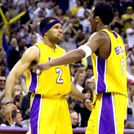 Derek Fisher celebrates one of his three-pointers with Bryant